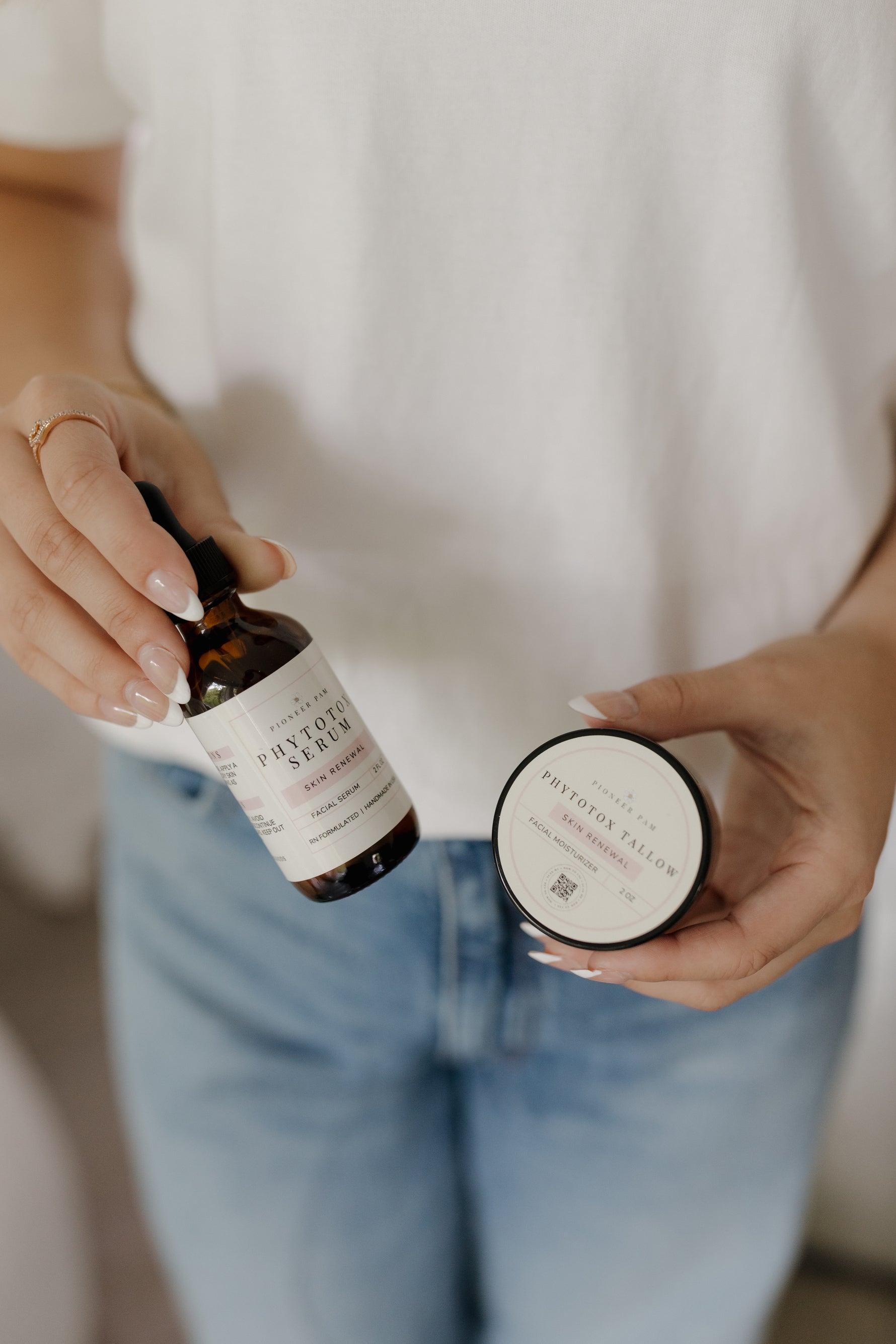 Woman holding Phytotox Serum and Phytotox Tallow together